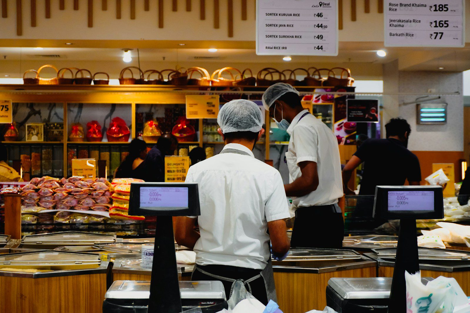 Workers in a grocery store checkout area