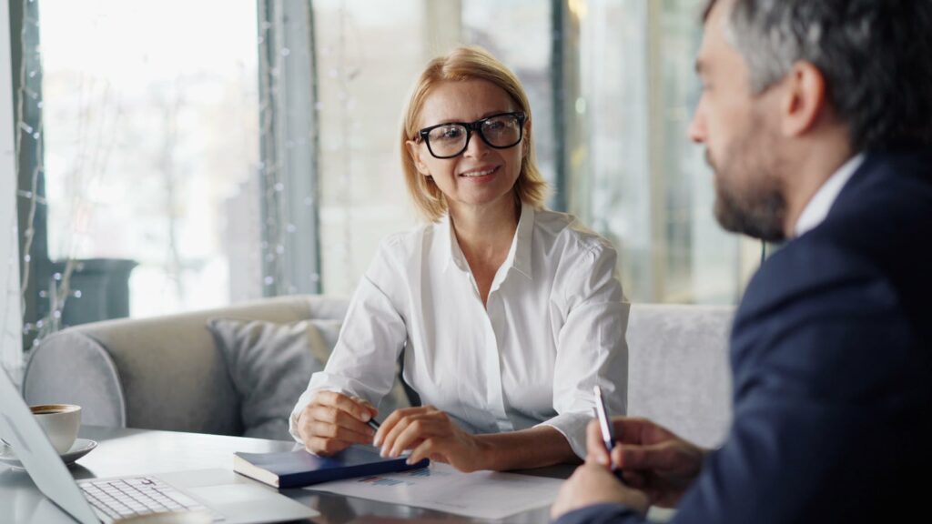 Confident businesspeople discussing strategies in a modern office setting.