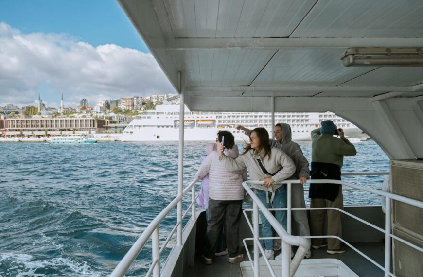 Tourists enjoy a boat ride on the Bosphorus in Istanbul with city views.