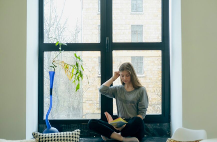 a person sitting next to a window