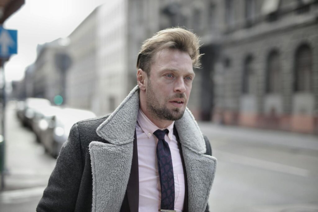 Portrait of a fashionable man in urban street setting on an overcast day.
