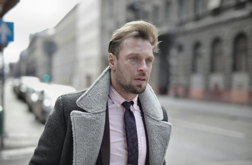 Portrait of a fashionable man in urban street setting on an overcast day.