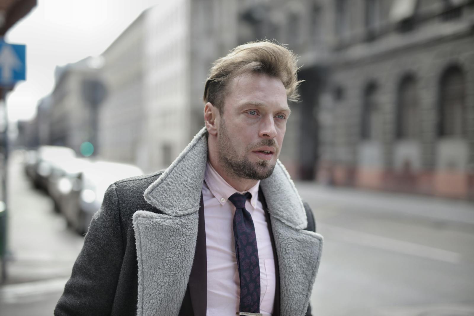 Portrait of a fashionable man in urban street setting on an overcast day.