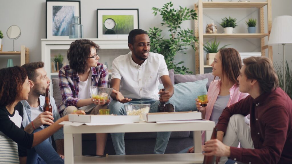 a group of people sitting on a couch talking