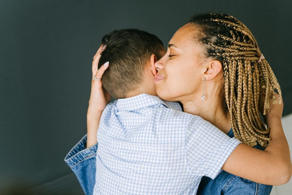 Tender moment of a mother embracing her child, expressing love and affection.