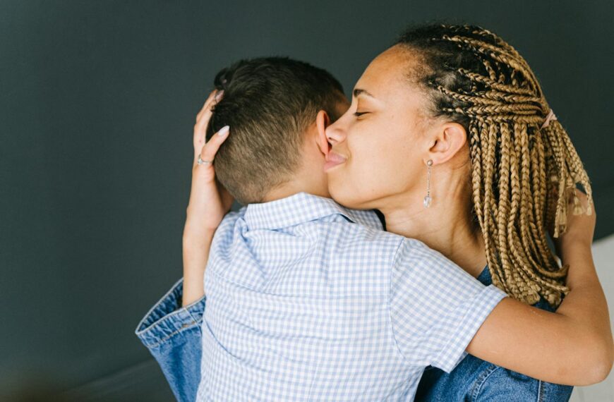 Tender moment of a mother embracing her child, expressing love and affection.
