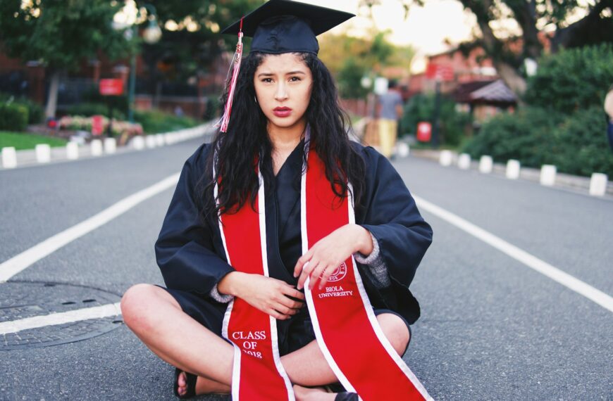 woman sitting on gray asphalt road