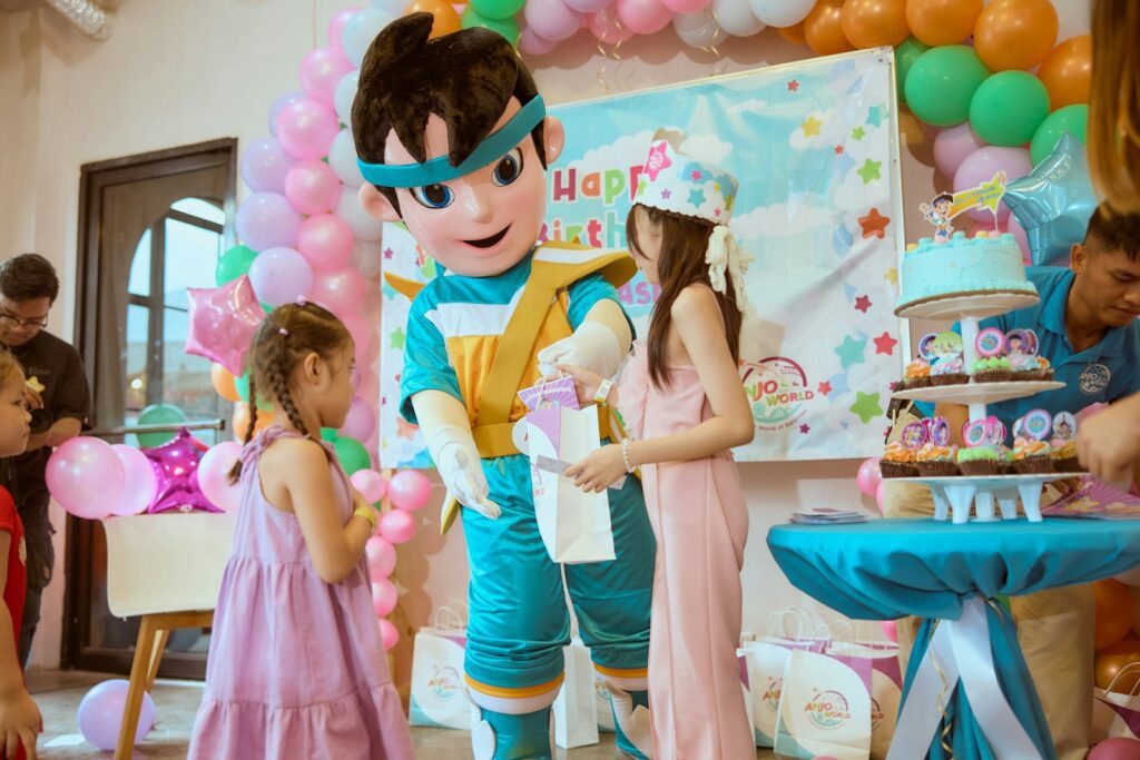 Mascot giving gift to girl at birthday party