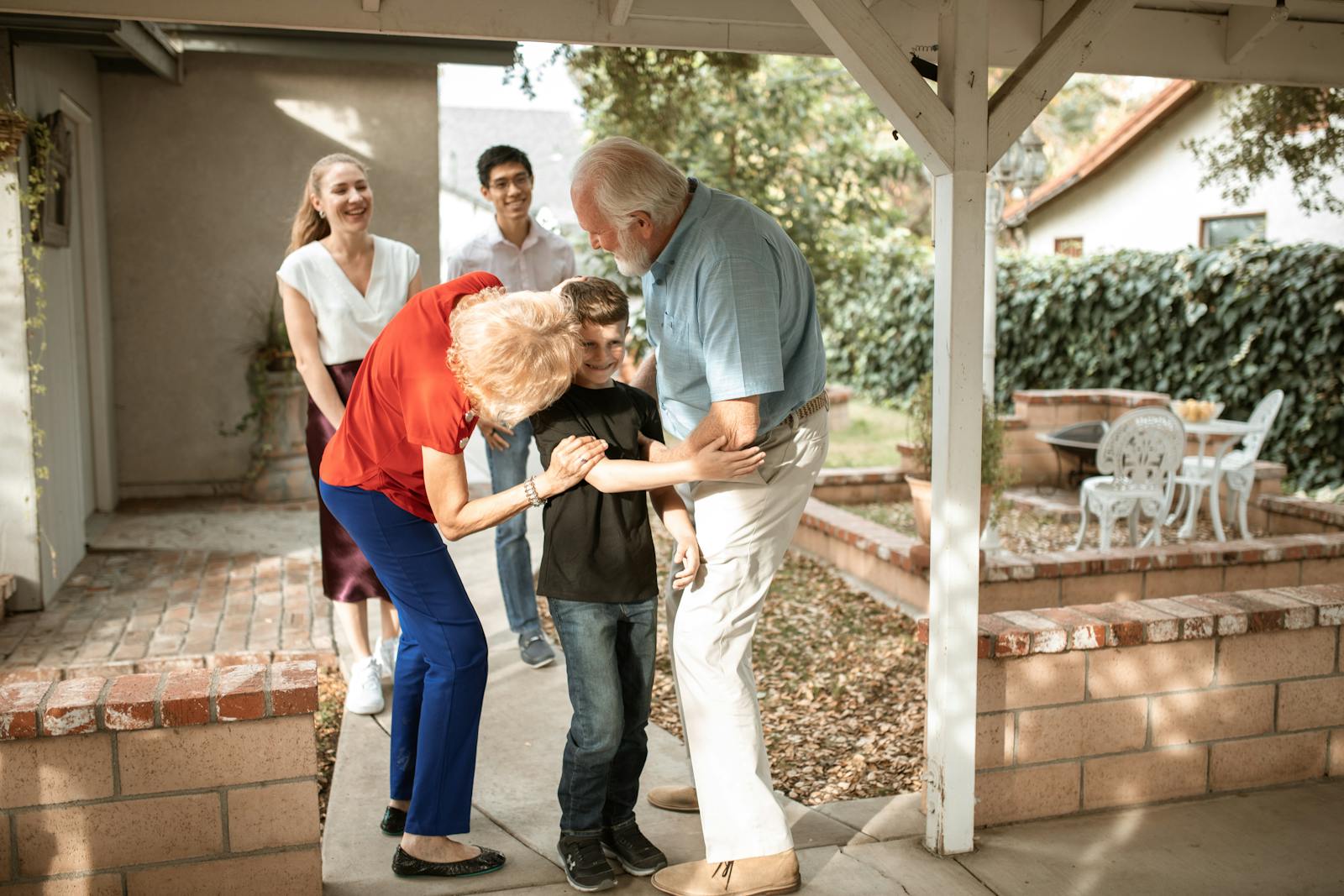 Multi-generational family sharing a joyful moment on the patio.