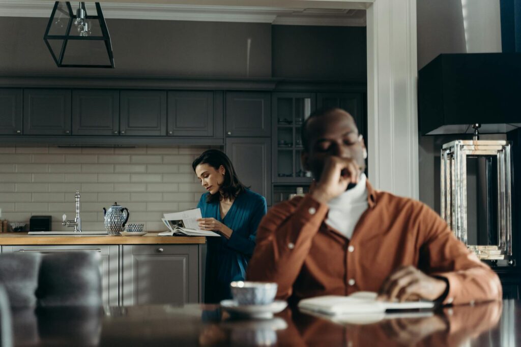 Elegant indoor scene of a couple enjoying a morning, reading and drinking coffee.