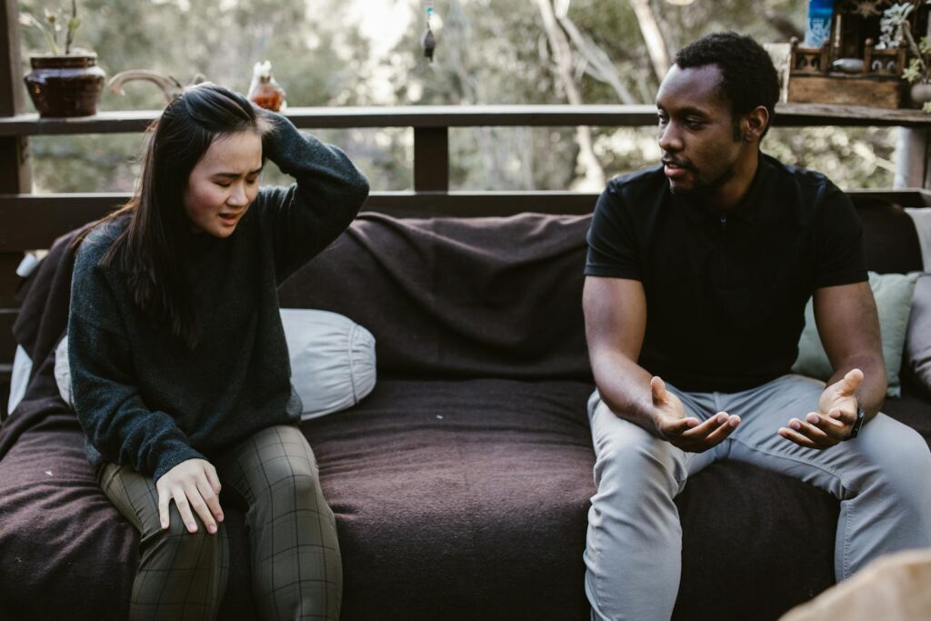 Couple having an intense discussion outdoors. Emotionally charged moment captured.