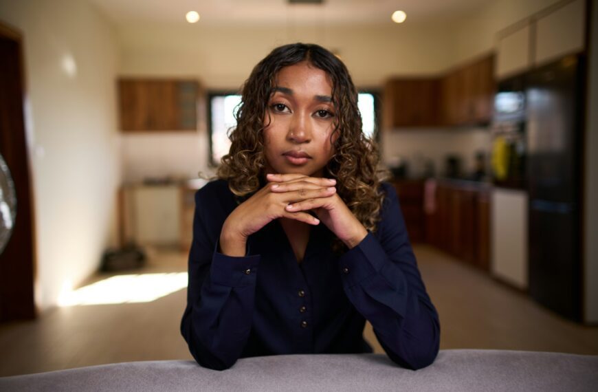 Young woman with curly hair looking at camera