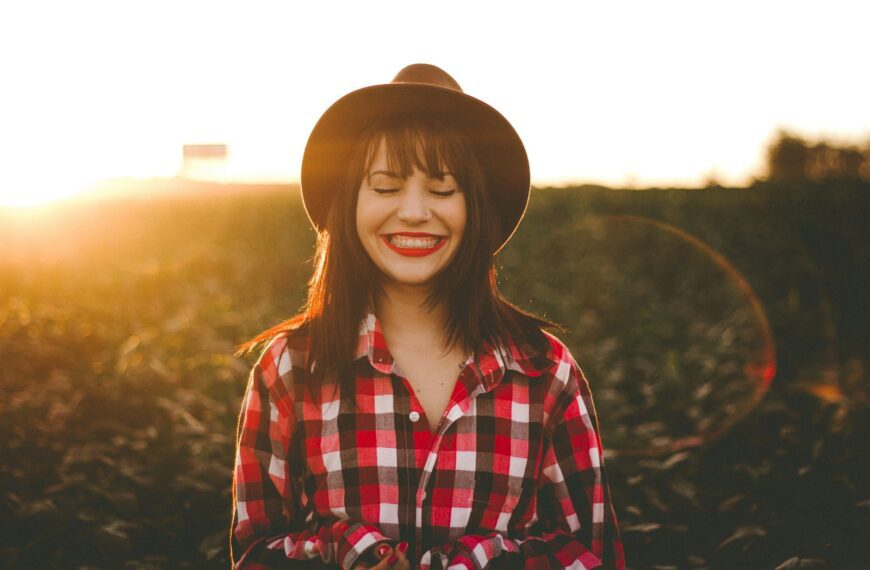 golden hour photography of woman in red and white checkered dress shirt