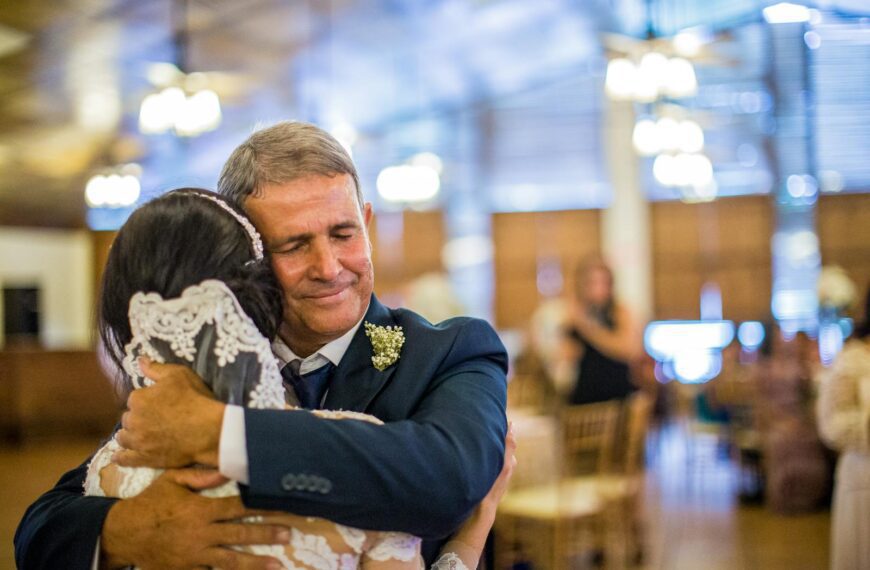 Emotional moment of a father hugging his daughter on her wedding day.