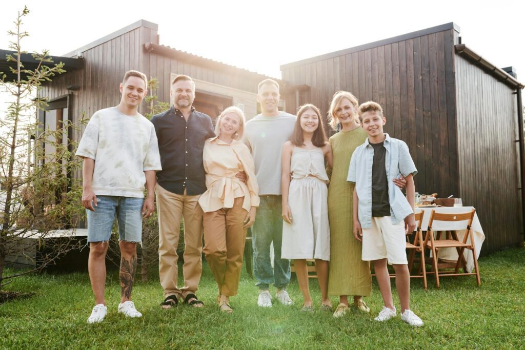 A joyful family posing together in a sunny outdoor setting, enjoying quality time.