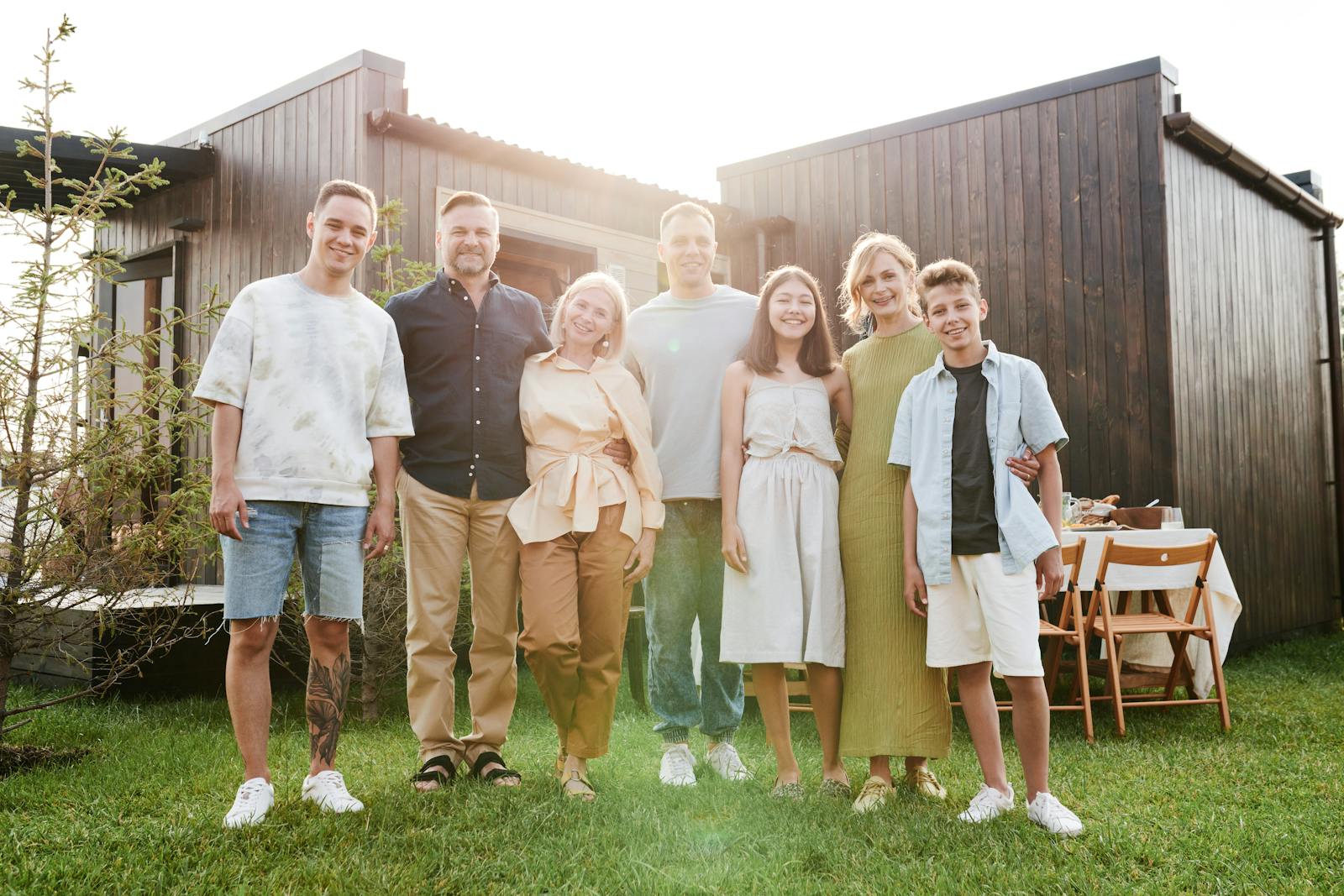 A joyful family posing together in a sunny outdoor setting, enjoying quality time.
