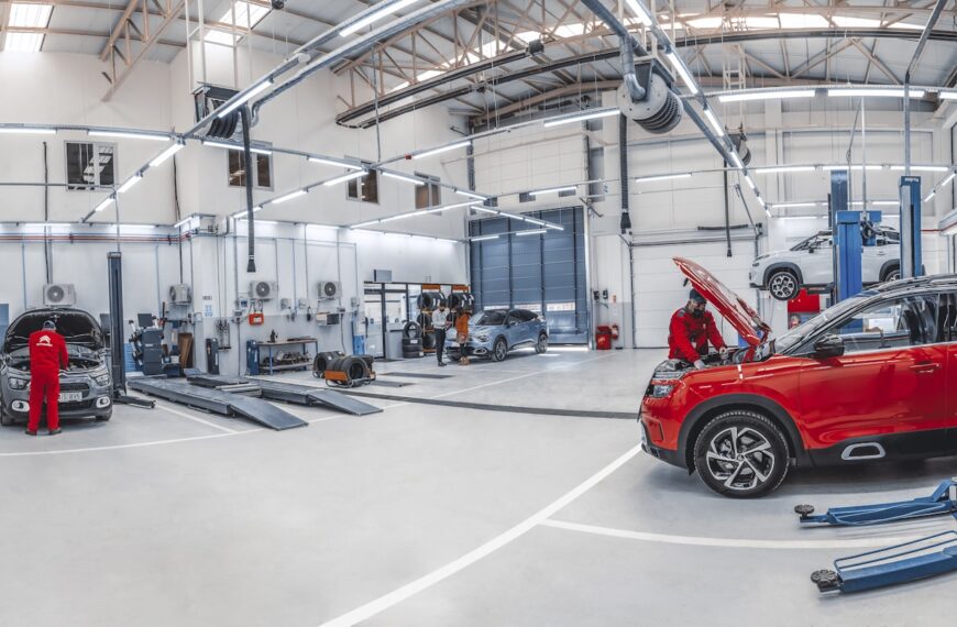 A red car is parked in a garage