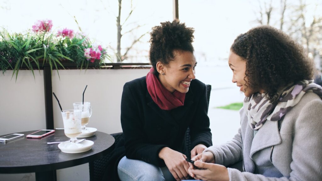 Two women talking at a cafe table