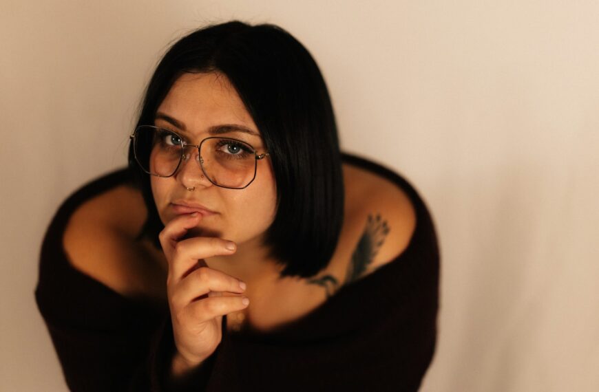 Young woman with dark hair wearing glasses