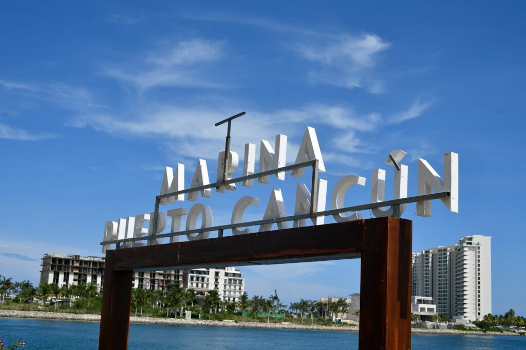 Marina puerto cancun sign with buildings and water