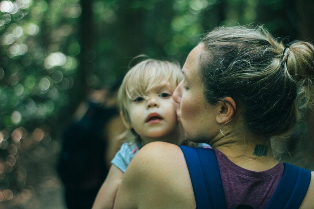 a woman holding a little girl in her arms