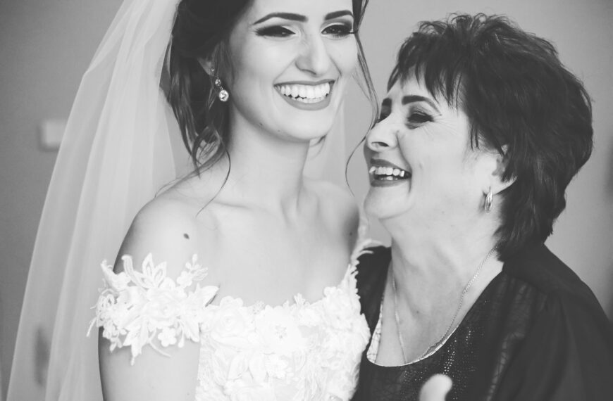 woman in white floral dress beside woman in black and white polka dot shirt