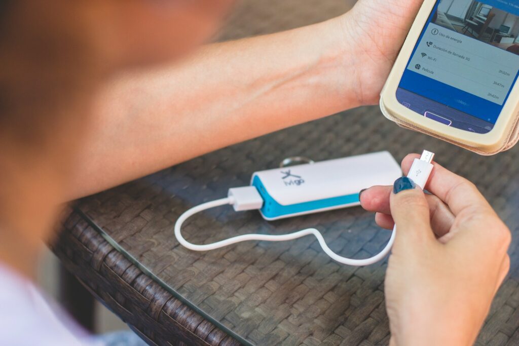 a person is plugging a charger into a cell phone