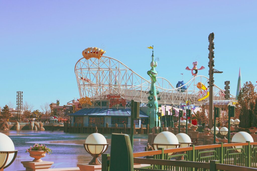 an amusement park with a roller coaster in the background