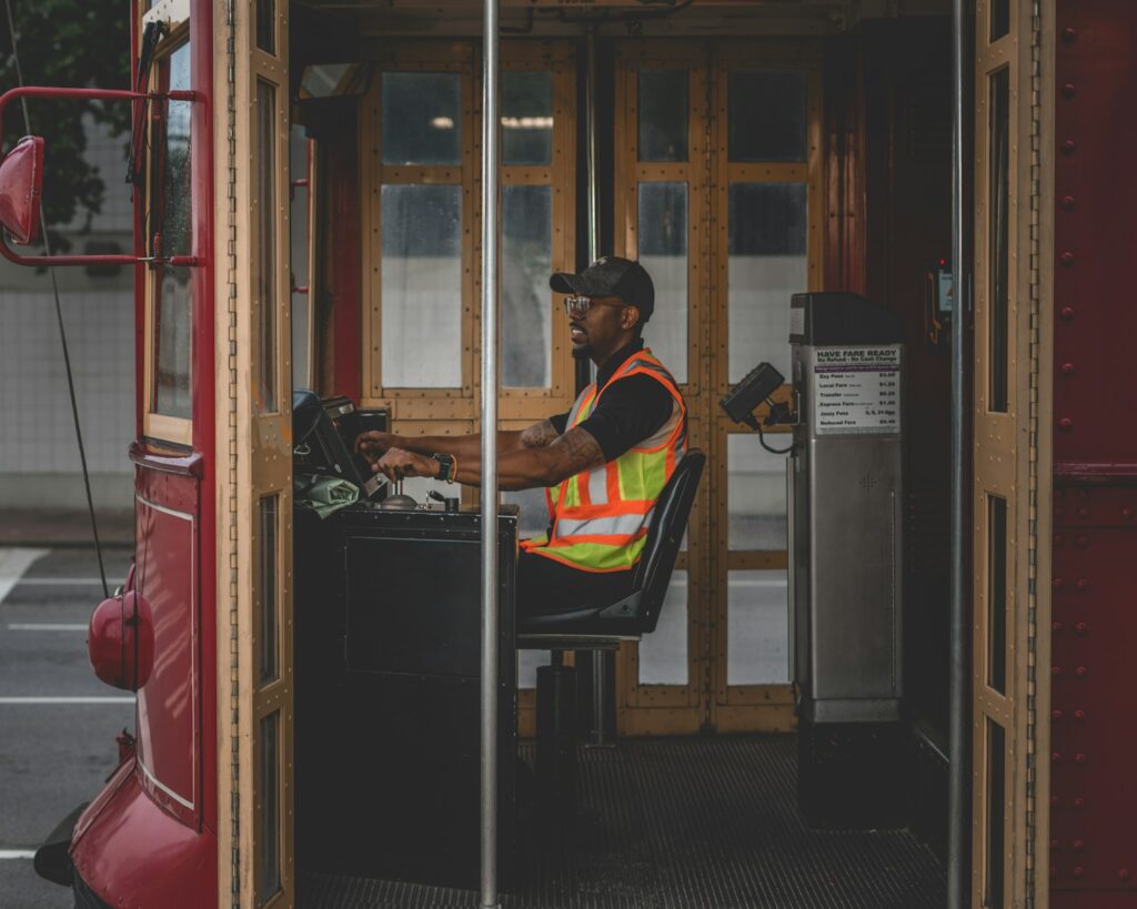 man sitting on chair controlling bus