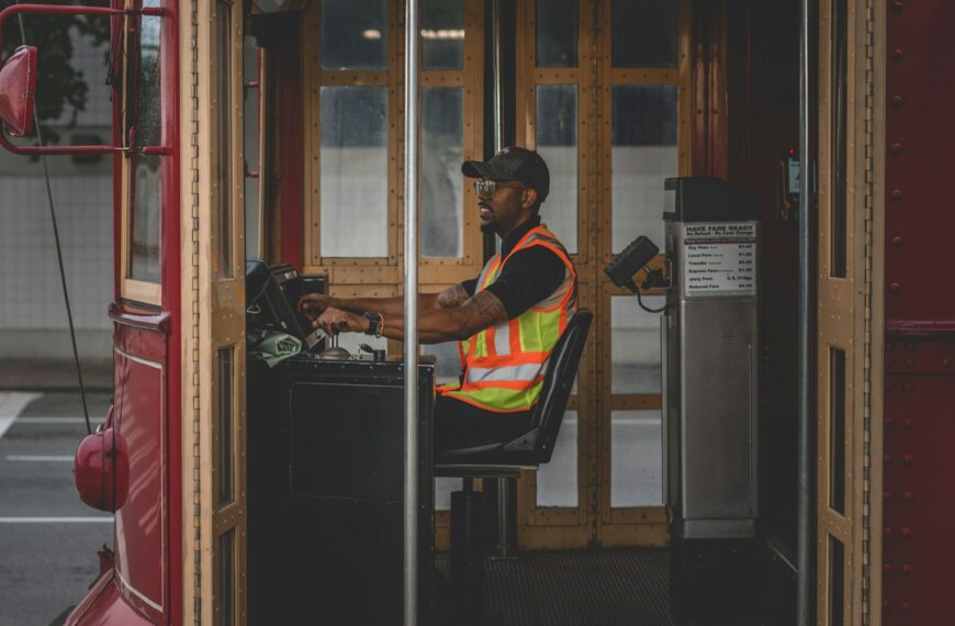 man sitting on chair controlling bus