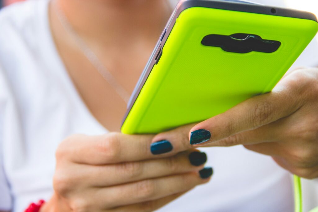 a close up of a person holding a cell phone
