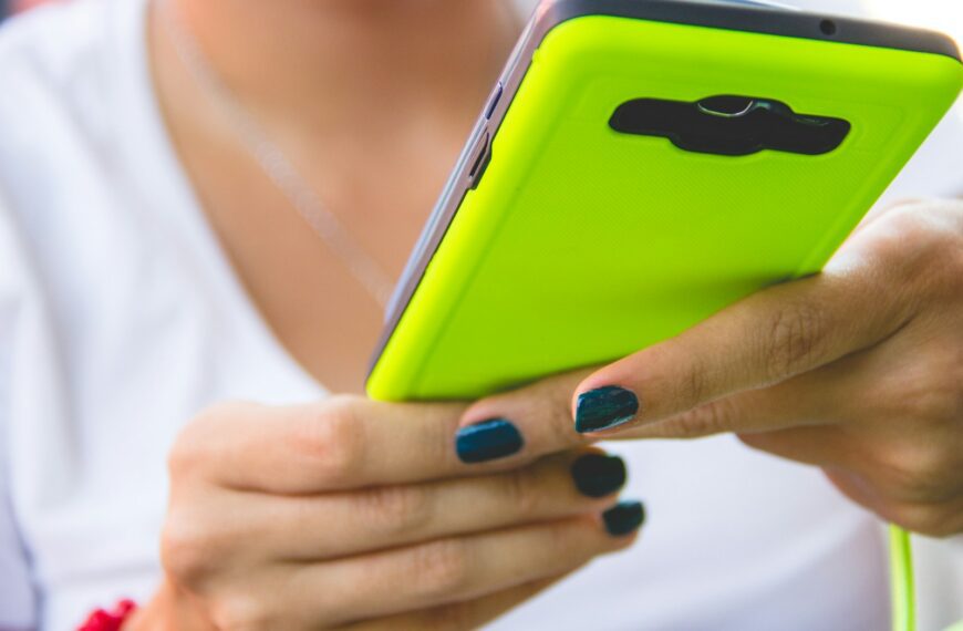 a close up of a person holding a cell phone