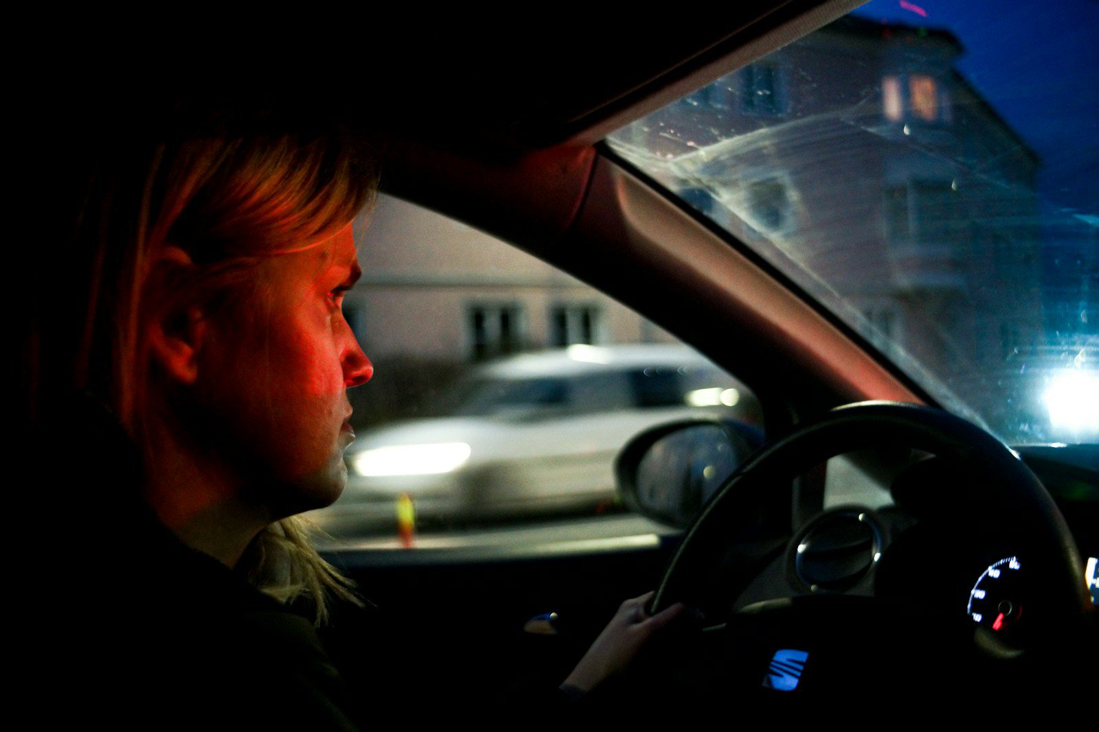 a man driving a car in the dark