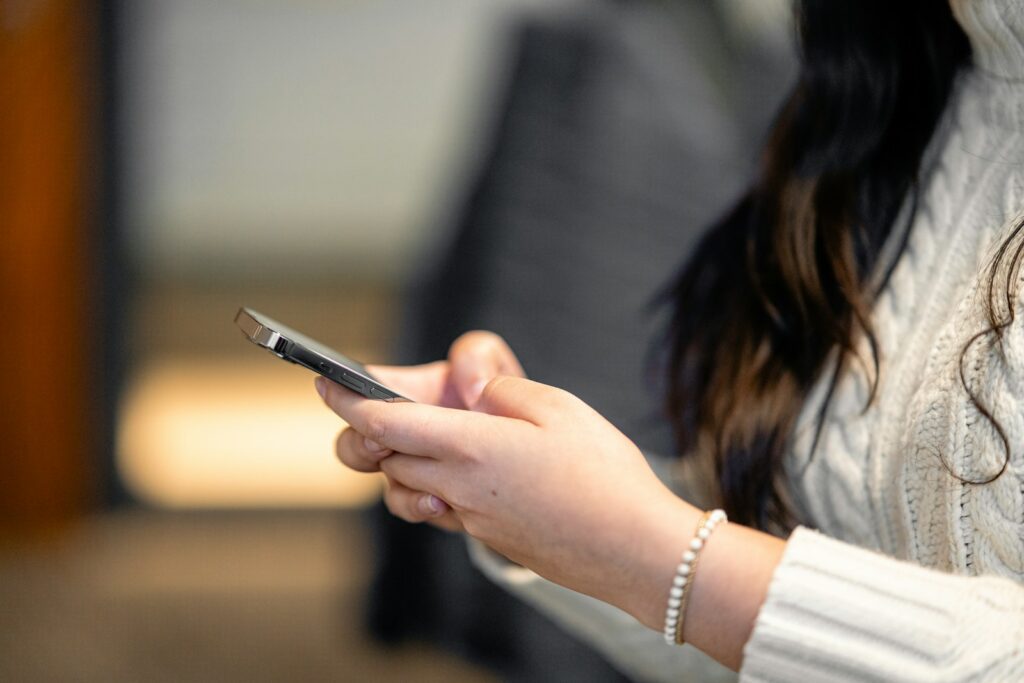 a close up of a person holding a cell phone