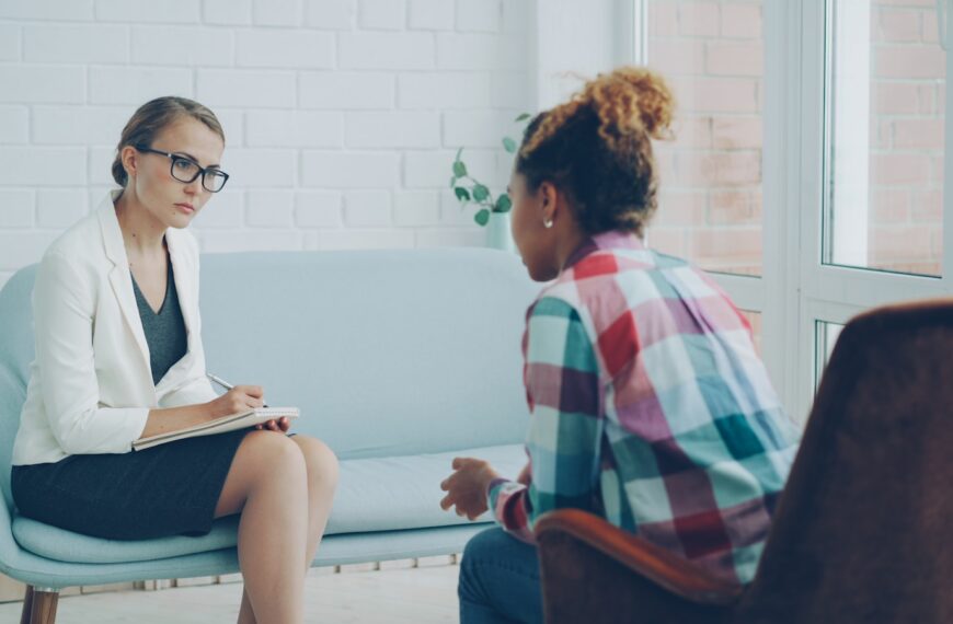 Therapist listens to patient in a counseling session.