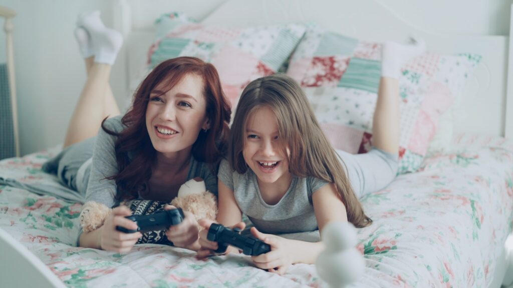 A mother and daughter play video games together.
