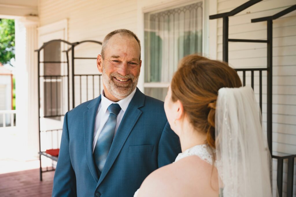 a man in a suit and tie standing next to a woman