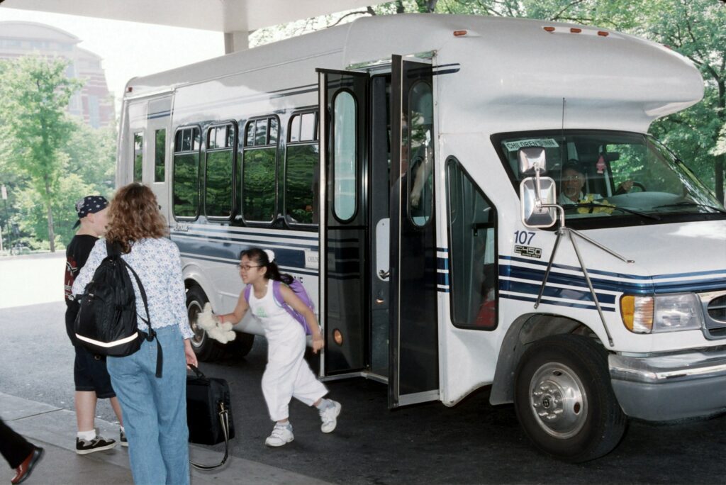 people standing beside white bus during daytime