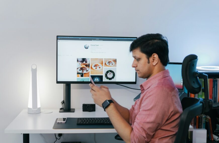 a man sitting at a desk looking at a screen