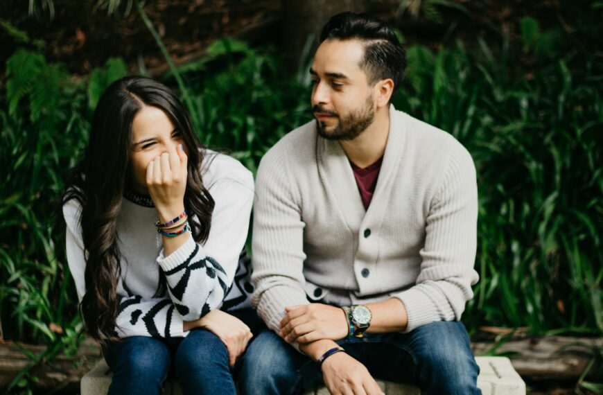man sitting beside smiling woman