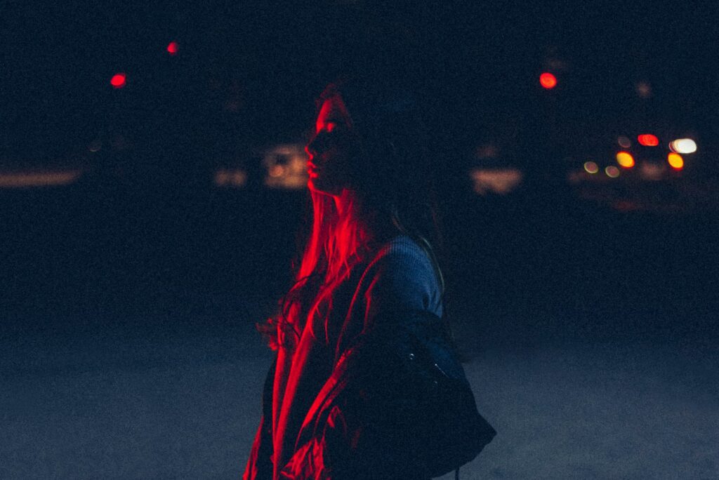 woman carrying bag during nighttime