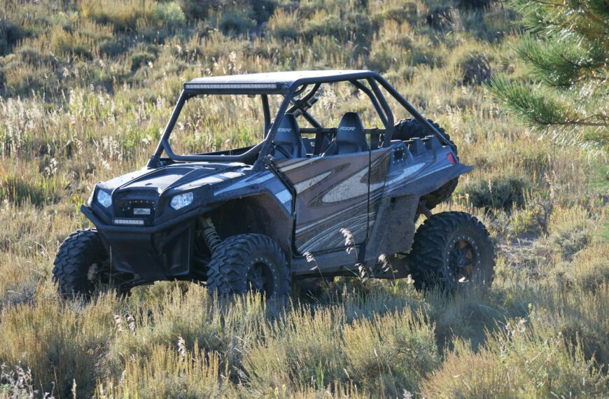a can - am commander off - roading through a field