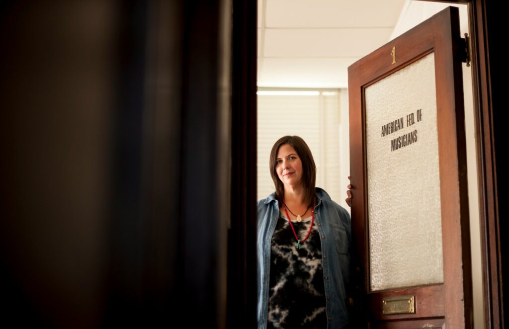 woman standing beside wooden door