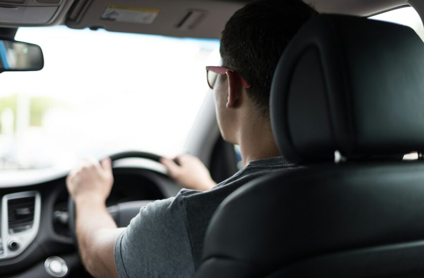 man driving car during daytime