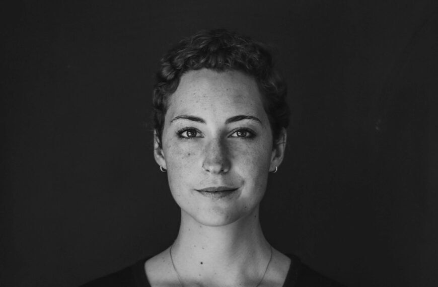 grayscale photo of woman wearing necklace and top