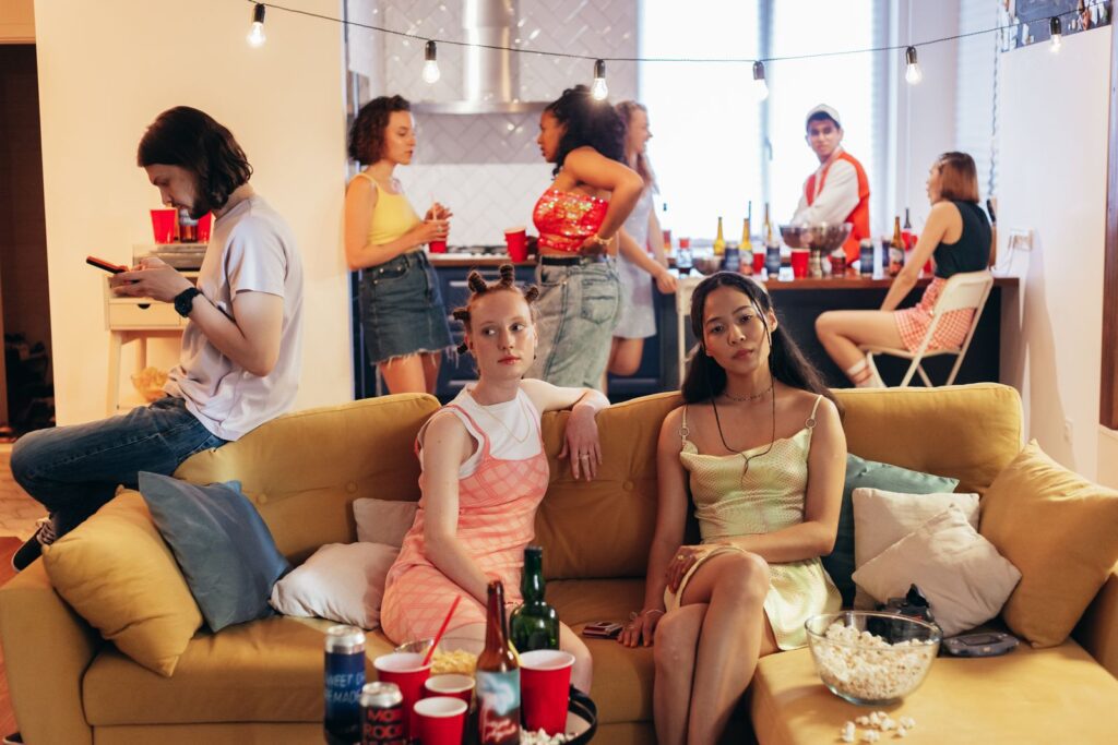 Energetic party with young adults socializing indoors. Modern and vibrant atmosphere.