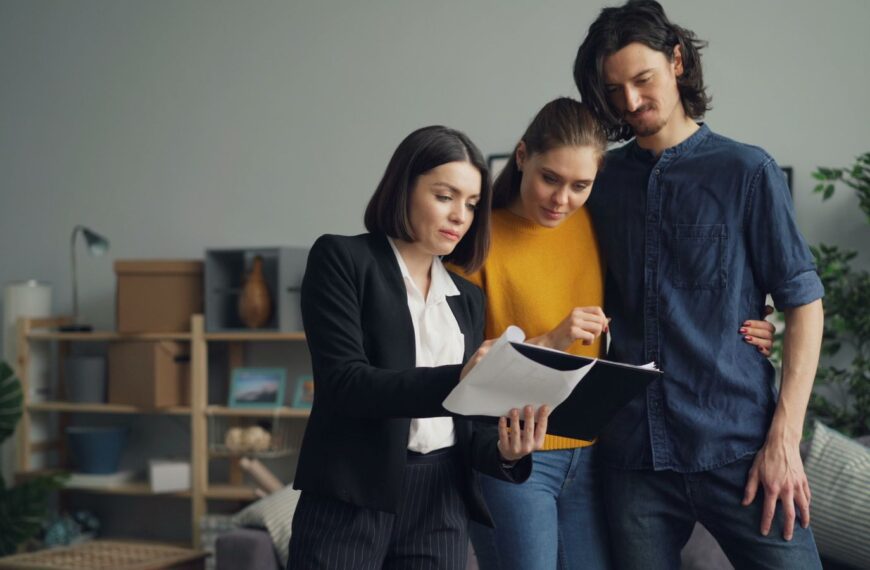 Young couple consulting with a real estate agent about property one indoors.