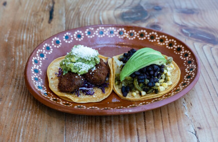 Close-up of delicious homemade tacos with fresh ingredients on a rustic wooden table.