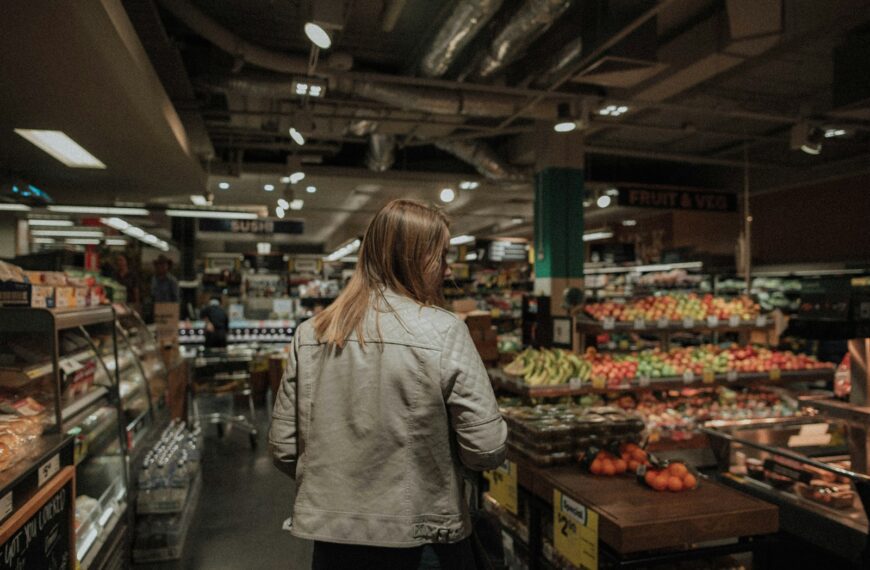 woman standing in front of assorted vegetables