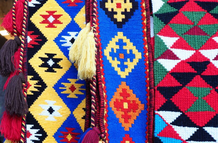 Vibrant handmade woven textiles featuring geometric patterns and colorful tassels, captured in Qatar.